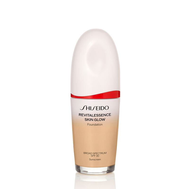 An oval-shaped bottle of Shiseido Revitalessence Skin Glow Foundation SPF 30 in shade 330 Bamboo. 瓶身上的标签为白色，带有红色点缀。标签上写有产品名称和, 防晒系数。