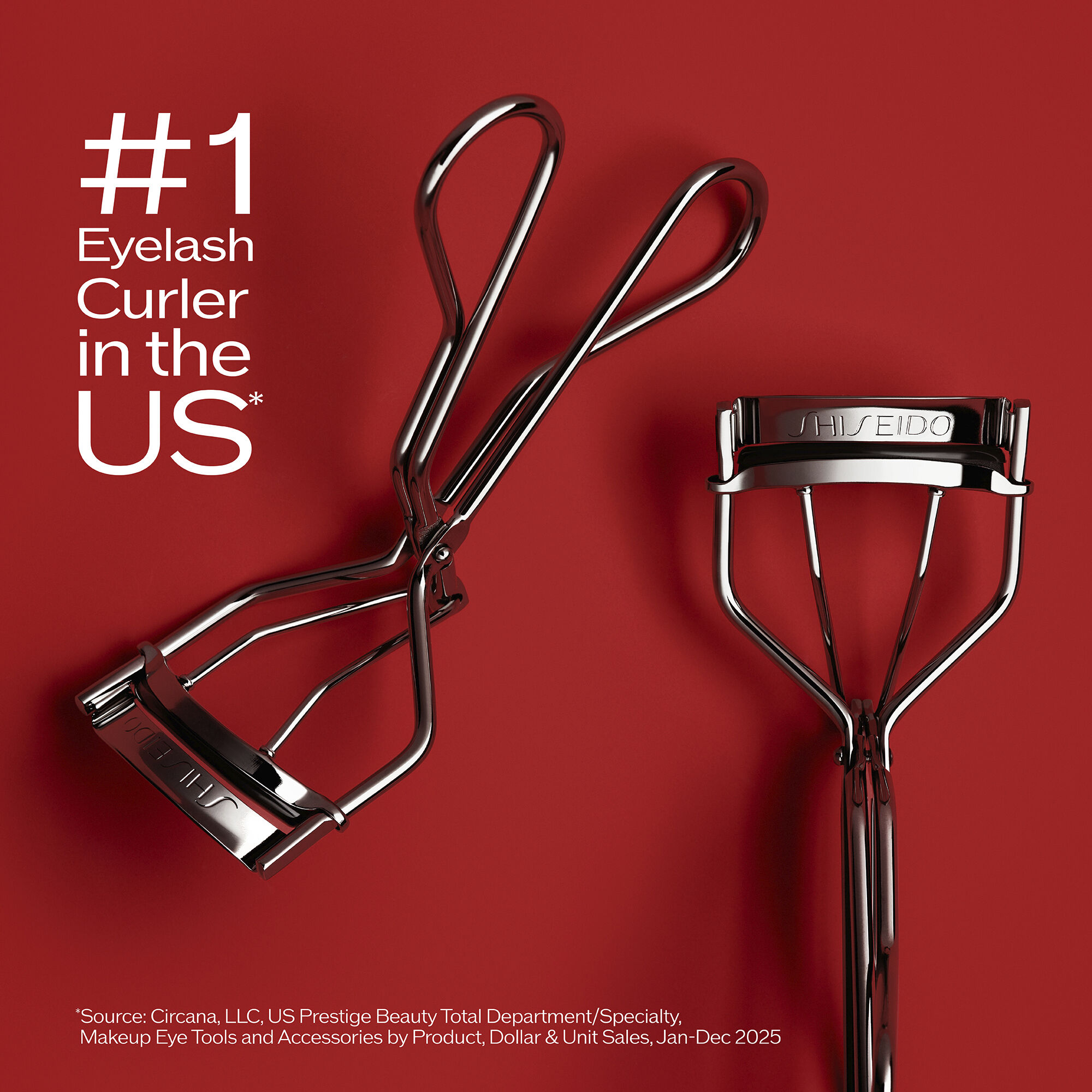 "The award-winning Shiseido Eyelash Curler, featuring the Shiseido logo, crimps and curls eyelashes. The makeup tool has a curved shape with two handles that meet at a hinge in the middle. "
