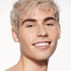 "A headshot of a model wearing the Shiseido Revitalessence Skin Glow Foundation SPF 30 in shade 260 Cashmere. The models’ skin appears more smooth and glowy with the foundation's medium-coverage finish.  "