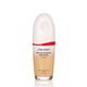 "An oval-shaped bottle of Shiseido Revitalessence Skin Glow Foundation SPF 30 in shade 230 Alder. The label on the bottle is white with a red accent. El texto en la etiqueta muestra el título del producto, and its sunscreen protection. "