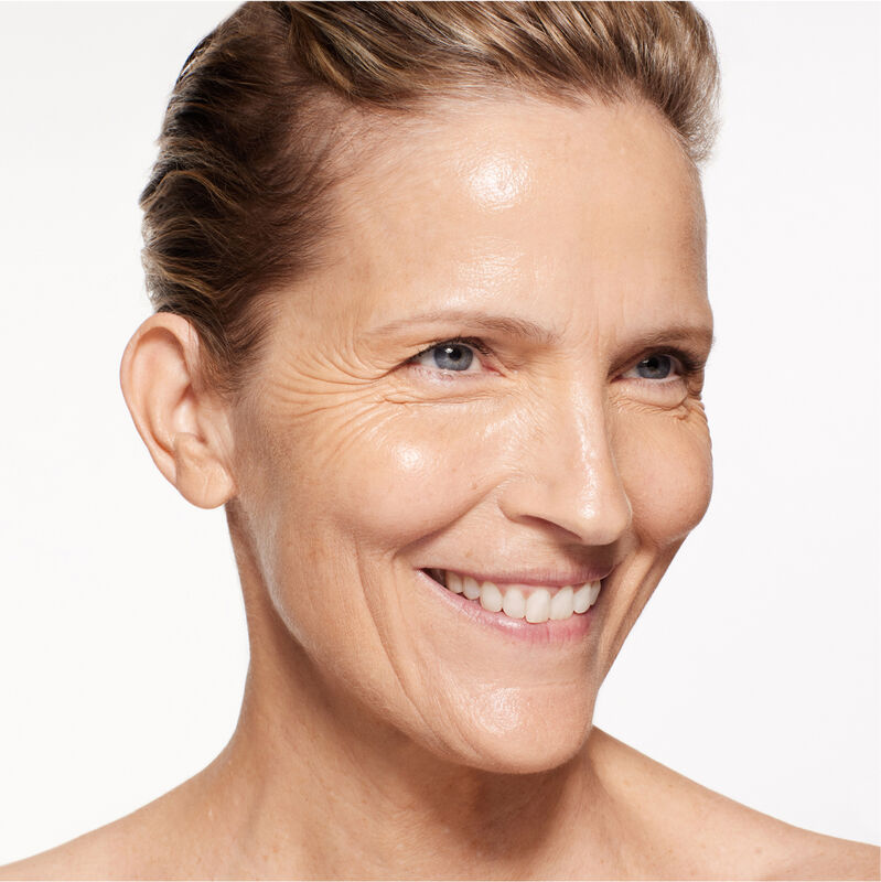 A headshot of a model wearing the Shiseido Revitalessence Skin Glow Foundation SPF 30 in shade 320 Pine. The models’ skin appears more smooth and glowy with the foundation's medium-coverage finish.