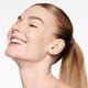 A headshot of a model wearing the Shiseido Revitalessence Skin Glow Foundation SPF 30 in shade 160 Shell. The models’ skin appears more smooth and glowy with the foundation's medium-coverage finish.