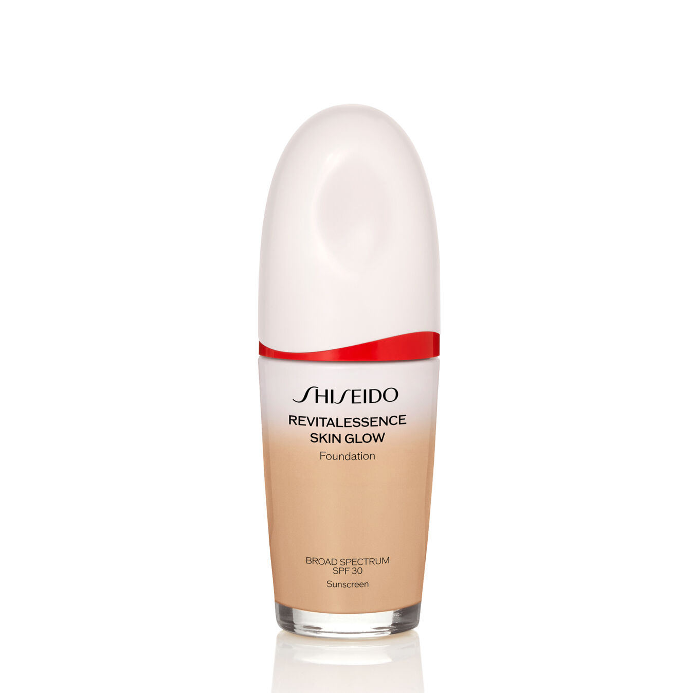 "An oval-shaped bottle of Shiseido Revitalessence Skin Glow Foundation SPF 30 in shade 310 Silk. The label on the bottle is white with a red accent. The text on the label reads the product&rsquo;s title, and its sunscreen protection. "